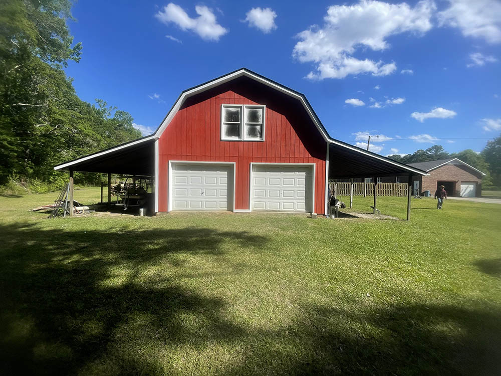 Completed double garage door barn elevation in Flower Pot with clean white trim